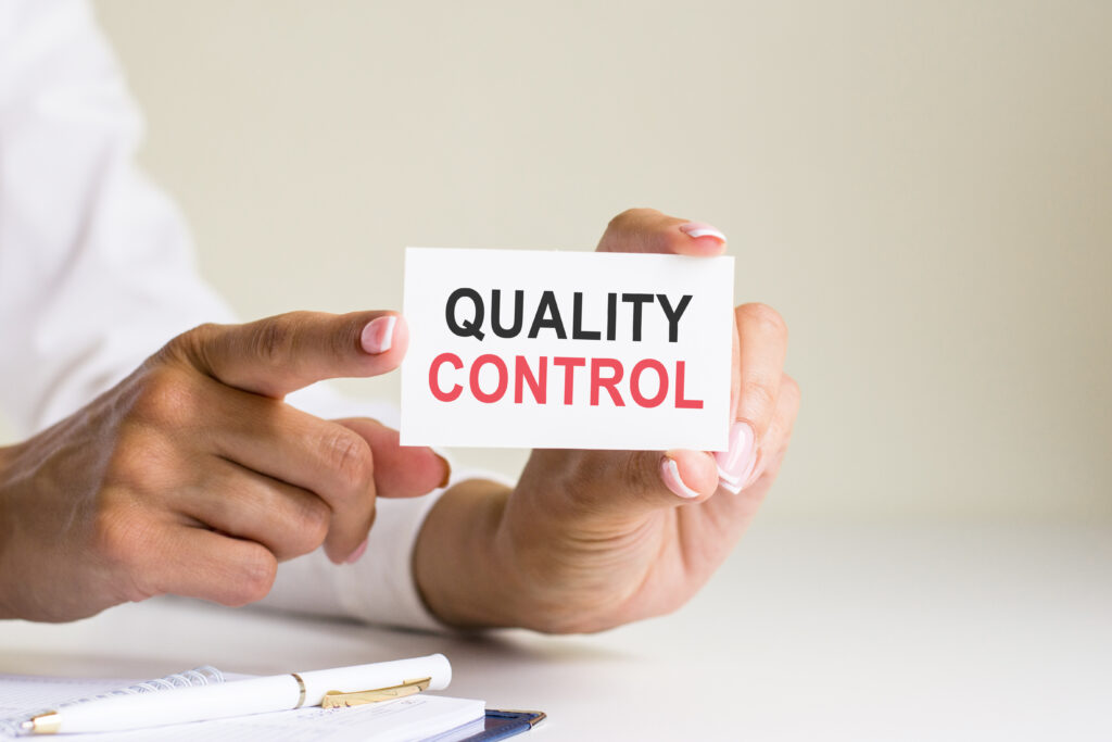 businesswoman holding a card with text Quality Control, concept