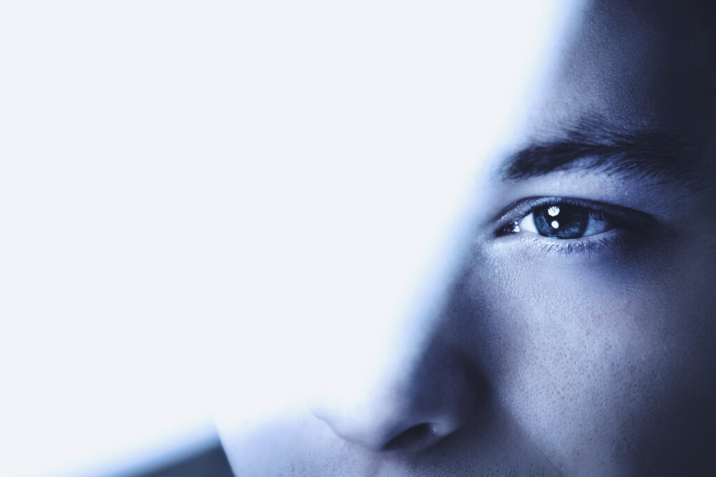 Thoughtful man looking through glass background business vision