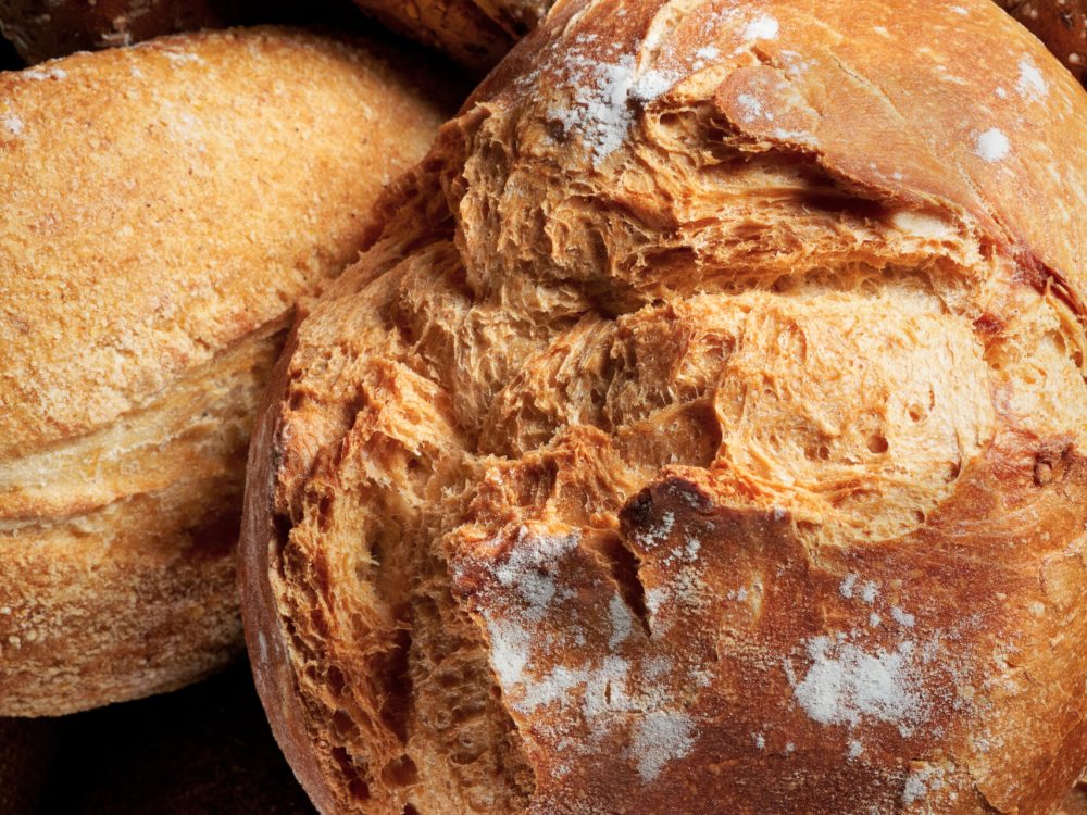 Different Types of Bread on dark background. Close up. Bakery concept.