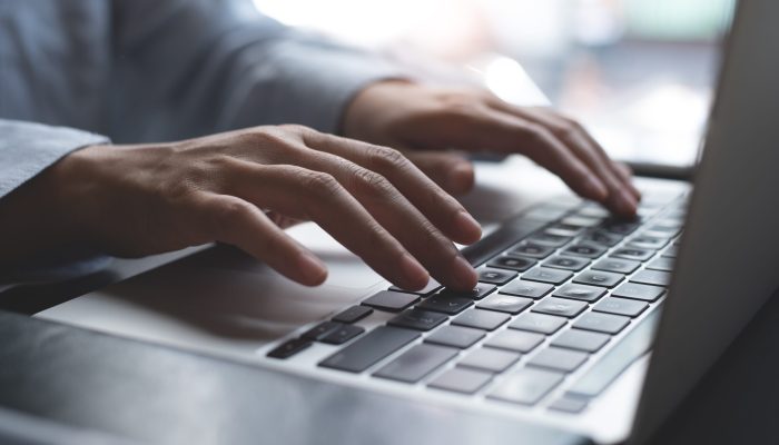 Close,Up,Of,Business,Woman,Hands,Working,,Typing,On,Laptop